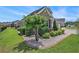 Front yard features a lush lawn, shrubbery, decorative stone, and a brick border, enhancing the home's curb appeal at 967 Henry James Dr., Myrtle Beach, SC 29579