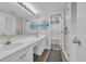 Clean, well-lit bathroom features double sinks, a large mirror, and a separate shower and toilet area at 101 Ocean Creek Dr. # Dd7, Myrtle Beach, SC 29572