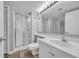 Clean bathroom features a shower with a glass door, white vanity, toilet and large mirror at 101 Ocean Creek Dr. # Dd7, Myrtle Beach, SC 29572