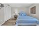 Comfortable bedroom with a single bed, a blue striped comforter and a nightstand with a lamp at 101 Ocean Creek Dr. # Dd7, Myrtle Beach, SC 29572