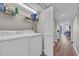 Bright laundry room featuring a side by side washer and dryer with storage shelf above at 101 Ocean Creek Dr. # Dd7, Myrtle Beach, SC 29572