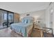 Well-lit main bedroom boasting balcony access with ocean views, a king bed, and tasteful coastal decor at 101 Ocean Creek Dr. # Dd7, Myrtle Beach, SC 29572