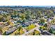 Aerial view of a neighborhood showcasing homes, lush greenery, and distant ocean skyline at 1014 Thomas Ave., North Myrtle Beach, SC 29582