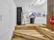A brightly lit bedroom with wooden stairs, featuring a bed and unique decor elements at 1014 Thomas Ave., North Myrtle Beach, SC 29582