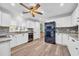 Bright kitchen with white cabinets, wood floors, and a modern stainless steel refrigerator at 1014 Thomas Ave., North Myrtle Beach, SC 29582