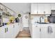 Modern kitchen with white cabinets, quartz countertops, and stainless steel appliances offers a clean and functional space at 1014 Thomas Ave., North Myrtle Beach, SC 29582