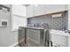 Functional laundry room with modern appliances, patterned backsplash, and ample storage, blending utility with style at 1014 Thomas Ave., North Myrtle Beach, SC 29582