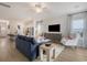 Open-concept living room with hardwood floors and seamless transition to the modern kitchen at 1100 Hainer Place Dr, Conway, SC 29526