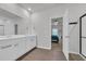 Bathroom with dual sinks, white cabinets, and ceramic tile floor, perfect for a modern and functional design at 112 Carolina Lakes Blvd., Myrtle Beach, SC 29588