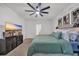 Comfortable bedroom featuring a ceiling fan, carpeted floor, and mounted television at 112 Carolina Lakes Blvd., Myrtle Beach, SC 29588