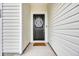 Close-up of a stylish black front door with a decorative wreath and modern hardware at 112 Carolina Lakes Blvd., Myrtle Beach, SC 29588