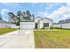 Charming single-story home features a manicured lawn and attached garage at 112 Carolina Lakes Blvd., Myrtle Beach, SC 29588