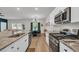Open-concept kitchen with stainless steel appliances and a granite countertop, perfect for culinary enthusiasts at 112 Carolina Lakes Blvd., Myrtle Beach, SC 29588
