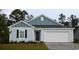 Charming single-story home features a two-car garage, blue siding, and well-manicured landscaping at 1126 Black Lake Way, Conway, SC 29526