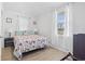 Inviting bedroom with floral bedding, soft natural light, and a calming atmosphere, perfect for restful nights at 113 Woodland Dr., Murrells Inlet, SC 29576