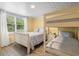 Bright bedroom with a twin sized bunk bed and twin bed offering a cozy space for rest and relaxation at 113 Woodland Dr., Murrells Inlet, SC 29576
