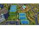 Aerial view of a community with tennis courts and a pool, surrounded by mature trees and landscaping at 125 South Dunes Dr., Pawleys Island, SC 29585
