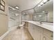 Well-lit bathroom with a shower, toilet, and a large mirror over the vanity at 125 South Dunes Dr., Pawleys Island, SC 29585