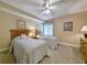 Bright bedroom featuring two twin beds, soft lighting, and a ceiling fan at 125 South Dunes Dr., Pawleys Island, SC 29585