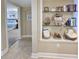 Hallway view with decorative shelves leading to a bedroom with a king bed at 125 South Dunes Dr., Pawleys Island, SC 29585