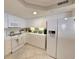 Bright kitchen featuring white appliances, ample counter space, and tile flooring at 125 South Dunes Dr., Pawleys Island, SC 29585