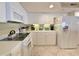 Clean kitchen featuring white appliances, ample cabinet space, and tiled floor for easy maintenance at 125 South Dunes Dr., Pawleys Island, SC 29585
