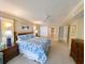Large bedroom with a king-sized bed, ceiling fan, and access to a bathroom at 125 South Dunes Dr., Pawleys Island, SC 29585