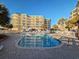 Community pool with clear water surrounded by resort and palm trees at 125 South Dunes Dr., Pawleys Island, SC 29585