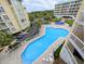 View from above of the pool area with lush landscaping between resort buildings at 125 South Dunes Dr., Pawleys Island, SC 29585