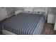 Bedroom featuring a queen-size bed with nautical-themed bedding and white nightstands at 1266 River Oaks Dr. # 12-F, Myrtle Beach, SC 29579