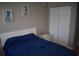 Cozy bedroom featuring a plush bed, nautical-themed art, and a spacious closet at 1266 River Oaks Dr. # 12-F, Myrtle Beach, SC 29579