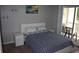 Comfortable bedroom with a neatly made bed and access to a private balcony at 1266 River Oaks Dr. # 12-F, Myrtle Beach, SC 29579