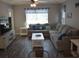 Comfortable living room with a large sectional sofa, wood flooring, and coastal decor at 1266 River Oaks Dr. # 12-F, Myrtle Beach, SC 29579