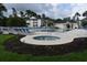 Community pool with a hot tub, lounge chairs and beautiful landscaping creating a relaxing outdoor space at 1266 River Oaks Dr. # 12-F, Myrtle Beach, SC 29579