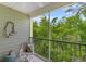 Enjoy the view from this screened-in balcony with comfortable seating and a ceiling fan at 144 Puffin Dr. # 3C, Pawleys Island, SC 29585