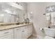 Well-lit bathroom featuring a granite vanity, mirror, and a toilet at 144 Puffin Dr. # 3C, Pawleys Island, SC 29585