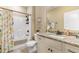 Well-lit bathroom featuring a granite countertop, white cabinets, and a shower-tub combo with a decorative shower curtain at 144 Puffin Dr. # 3C, Pawleys Island, SC 29585