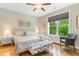 Bright bedroom with a large window and a comfortable seating area at 144 Puffin Dr. # 3C, Pawleys Island, SC 29585