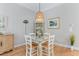 Charming dining area with rustic table set, pendant lighting, and stylish decor at 144 Puffin Dr. # 3C, Pawleys Island, SC 29585