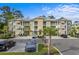 Well-maintained condo building with balconies, lush landscaping, and ample parking space at 144 Puffin Dr. # 3C, Pawleys Island, SC 29585