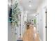 Bright hallway with hardwood floors leading to living spaces and a stylish decorative wreath at 144 Puffin Dr. # 3C, Pawleys Island, SC 29585