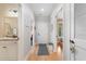 Bright hallway showcasing hardwood floors, white trim, and doorways leading to various rooms in the home at 144 Puffin Dr. # 3C, Pawleys Island, SC 29585