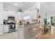 Modern kitchen with white cabinets, stainless steel appliances, and counter seating at 144 Puffin Dr. # 3C, Pawleys Island, SC 29585