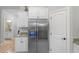 Modern kitchen with granite countertops, stainless steel refrigerator, and white cabinetry at 144 Puffin Dr. # 3C, Pawleys Island, SC 29585