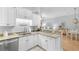 Open-concept kitchen with granite counters, white cabinets, and modern stainless steel appliances at 144 Puffin Dr. # 3C, Pawleys Island, SC 29585