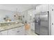 Open kitchen with granite countertops, stainless steel refrigerator, and adjacent breakfast nook at 144 Puffin Dr. # 3C, Pawleys Island, SC 29585