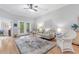Cozy living room with natural light, neutral decor, ceiling fan, and outdoor access at 144 Puffin Dr. # 3C, Pawleys Island, SC 29585