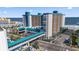 Expansive aerial view of the condo building near the ocean, showcasing its bridge and outdoor amenities at 1501 S Ocean Blvd. # 1231, Myrtle Beach, SC 29577