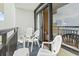 Relaxing balcony with three chairs and sliding glass doors leading to a well-lit interior at 1501 S Ocean Blvd. # 1231, Myrtle Beach, SC 29577