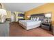 Bright bedroom with a king bed, mini kitchen, and warm, inviting decor at 1501 S Ocean Blvd. # 1231, Myrtle Beach, SC 29577